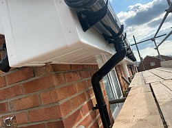 White fascia & soffit with black guttering